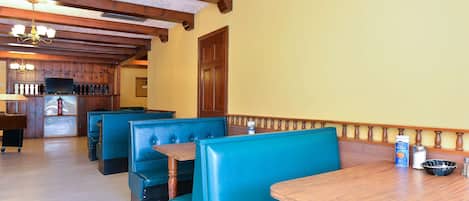 Un restaurant amb seients a boxes i una taula de fusta.