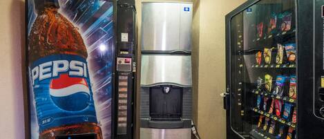 A vending machine with a Pepsi logo, a water dispenser, and a snack vending machine.