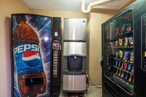 A vending machine with a Pepsi logo, a water dispenser, and a snack vending machine. - Red Roof Inn Augusta - Washington Road (Augusta)
