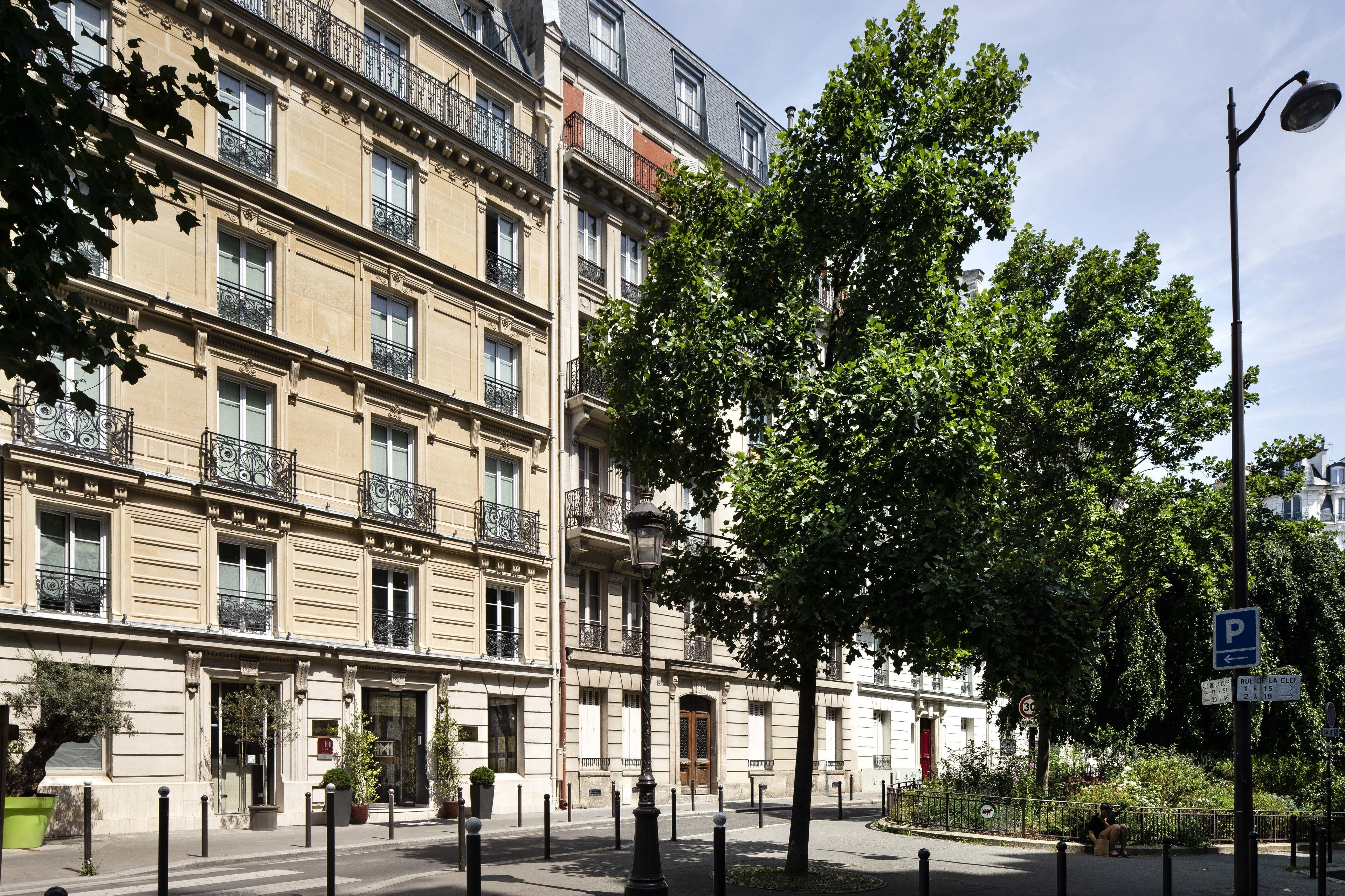 A multi-story building with a classic architectural style, featuring balconies and large windows.