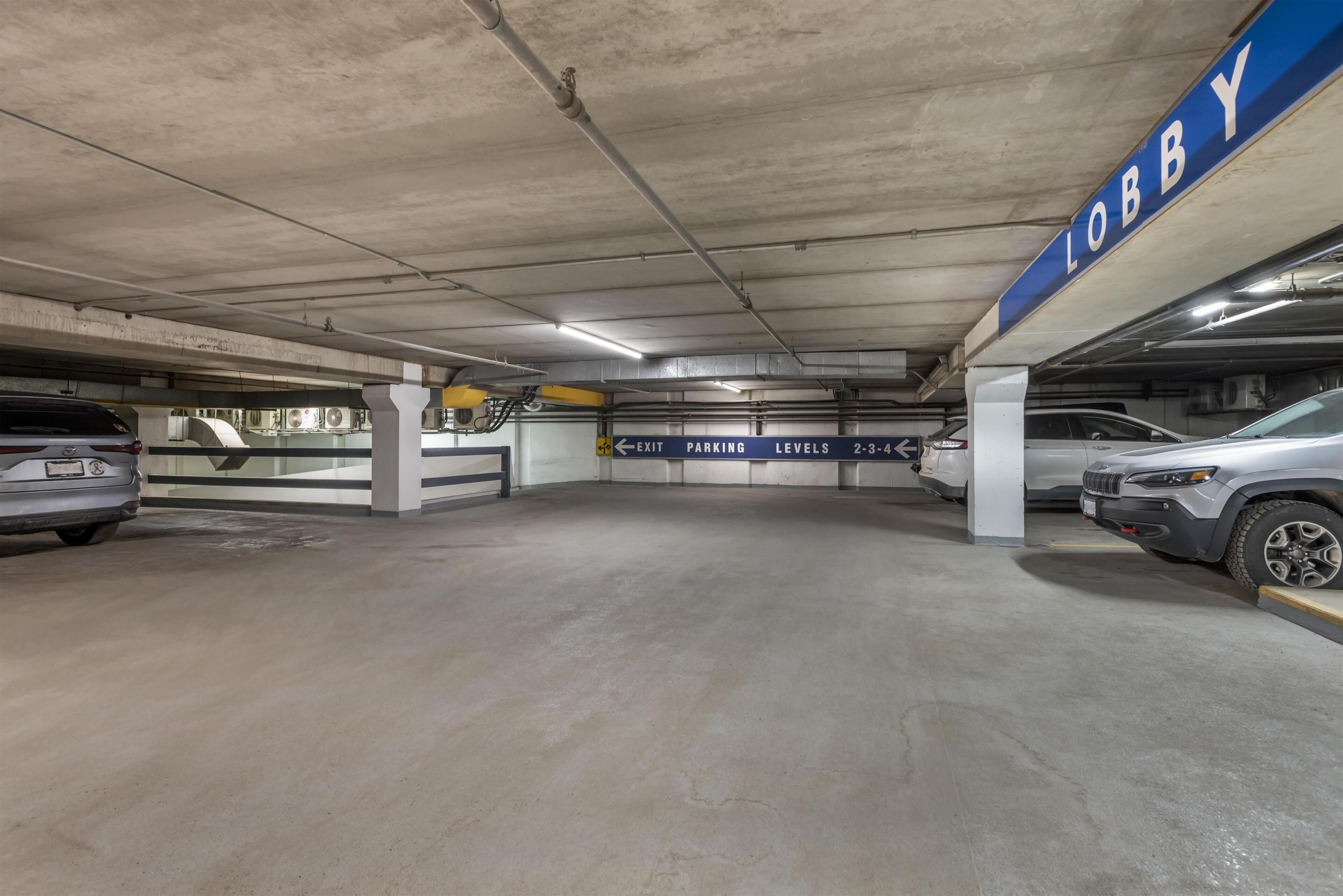 A multi-level parking garage with clear signage indicating levels and an exit.
