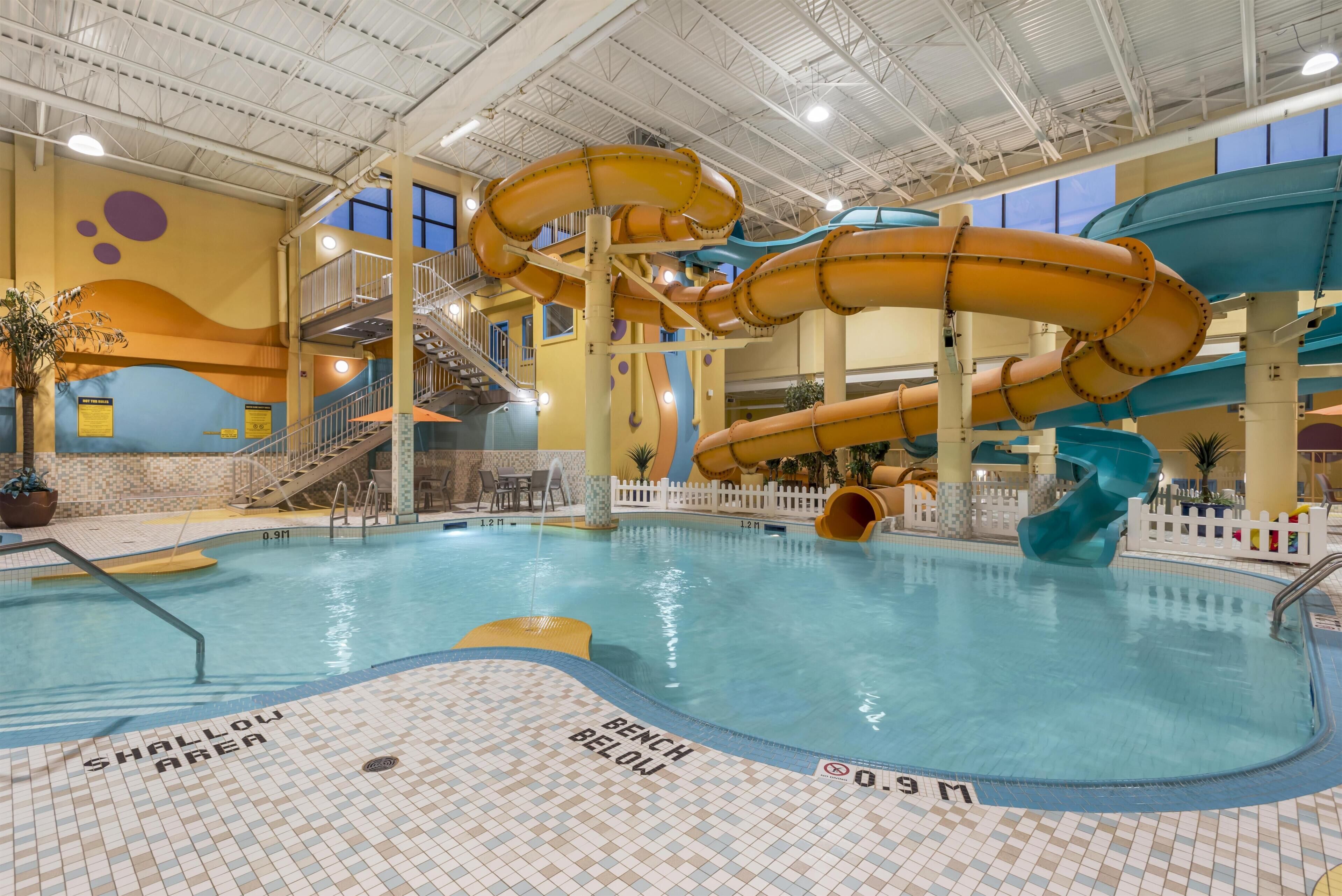 An indoor pool with multiple slides and a shallow area marked.