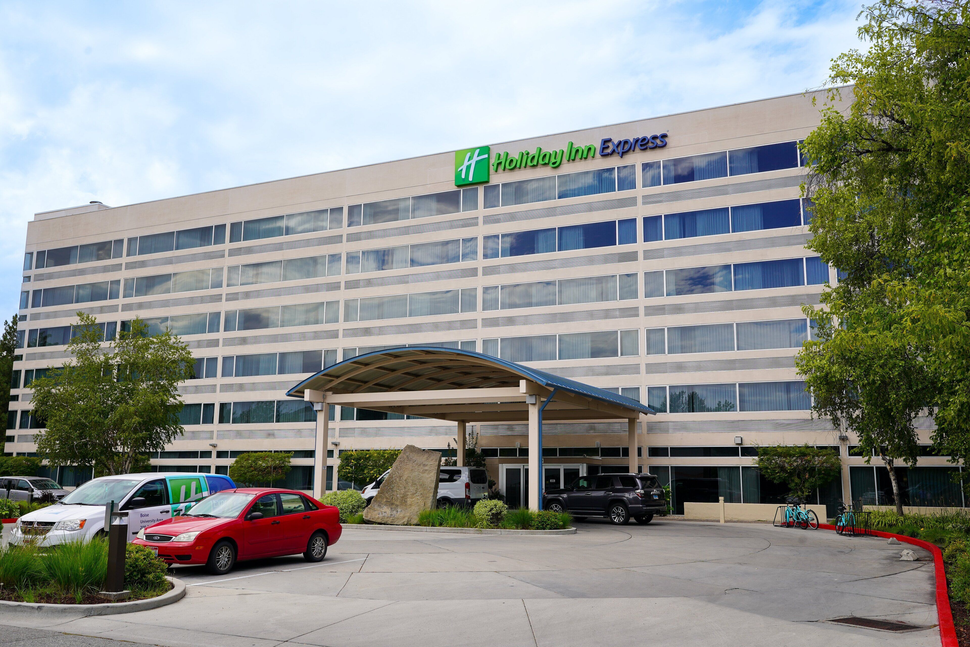 A Holiday Inn Express hotel with a covered parking area and a large building facade.