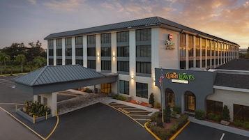 A hotel with a modern design, featuring a prominent entrance and signage for 'Premier Best Western' and 'Curry Leaves Fine Indian Cuisine'.