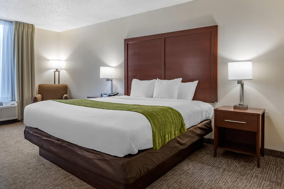 Premium bedding, desk, laptop workspace, blackout drapes