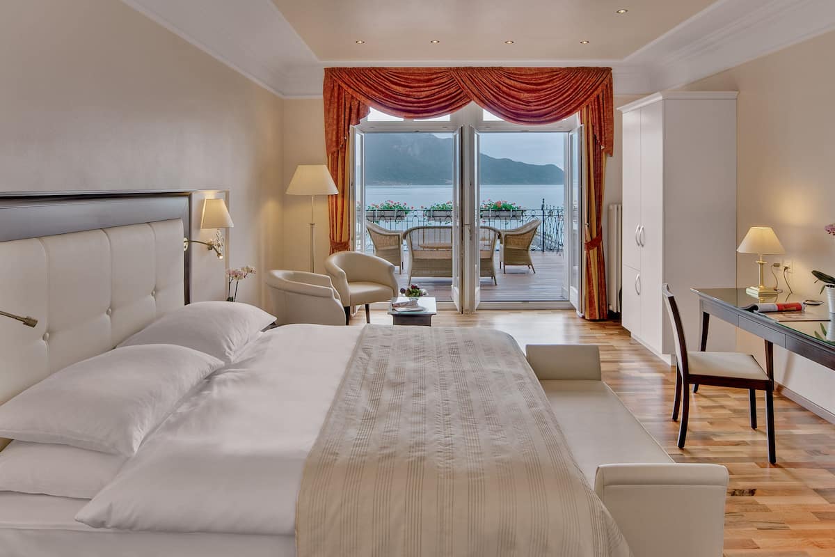 junior suite, 1 queen bed, non smoking, lake view | 1 bedroom, premium bedding, free minibar, in-room safe