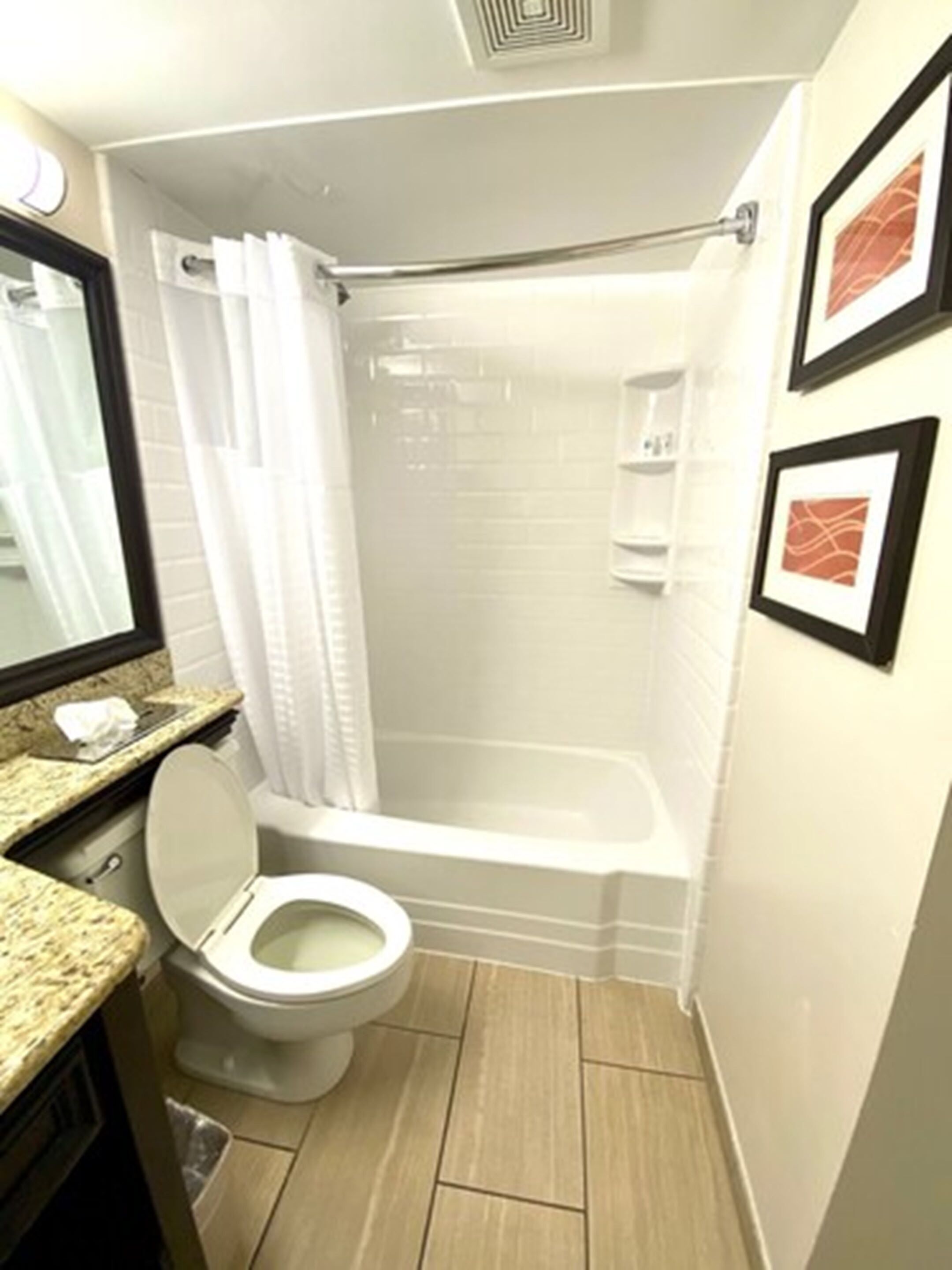 A bathroom with a toilet, a shower, and a bathtub.