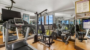 A gym with treadmills, weight machines, and a mirrored wall. - Comfort Inn Oceanside Deerfield Beach (Deerfield Beach)