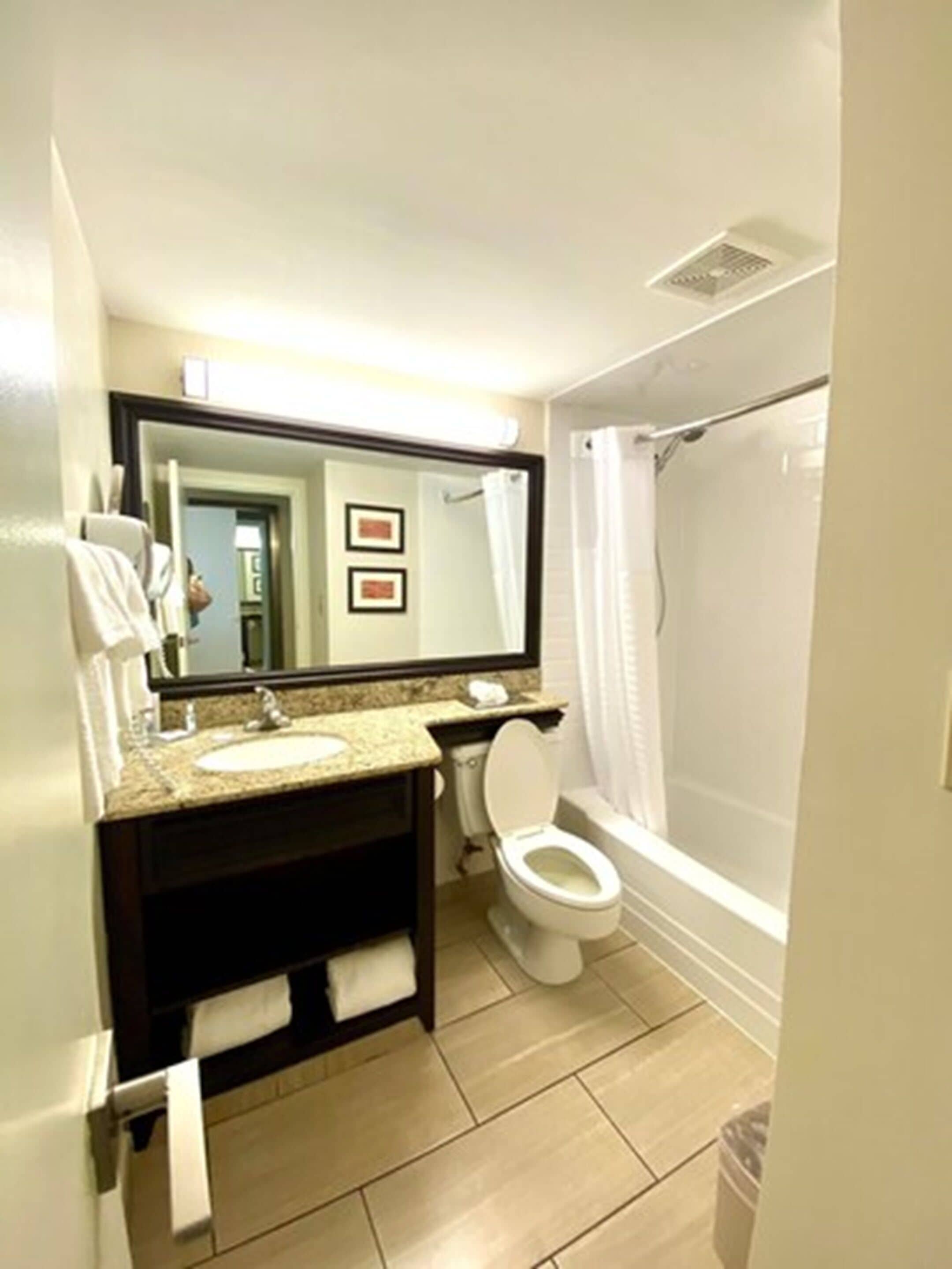 A bathroom with a sink, toilet, and shower.