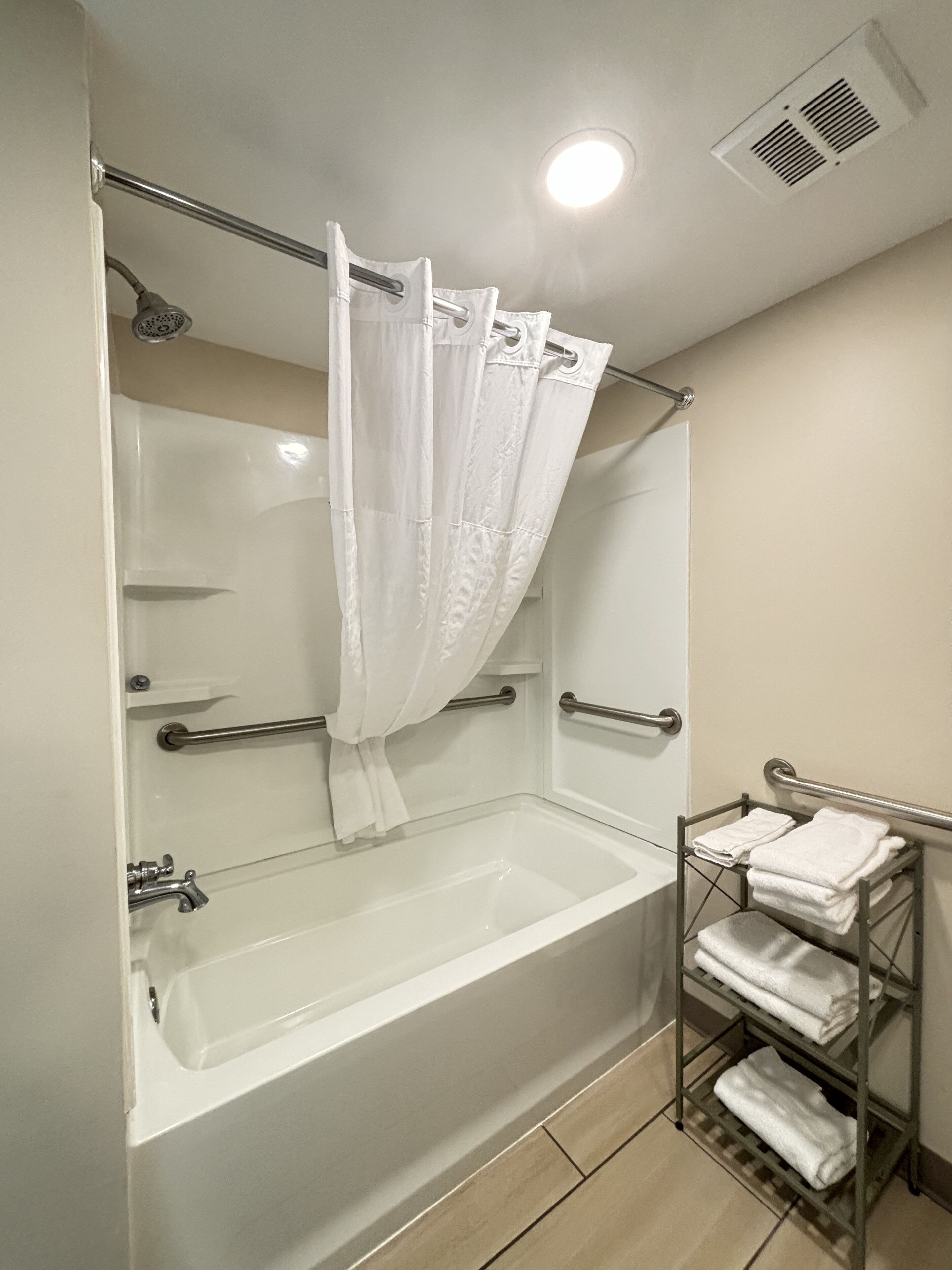 1 king bed mobility accessible room bathtub/shower w/ grab bars, non smoking | bathroom | hair dryer, towels