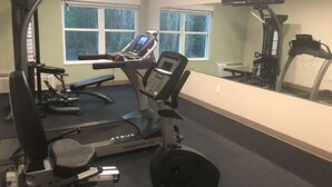 A gym with a treadmill, weight bench, and various exercise machines. - Baymont by Wyndham Lake Park Valdosta I-75 (Lake Park)