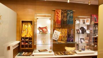 A jewelry display with various items and a patterned curtain.