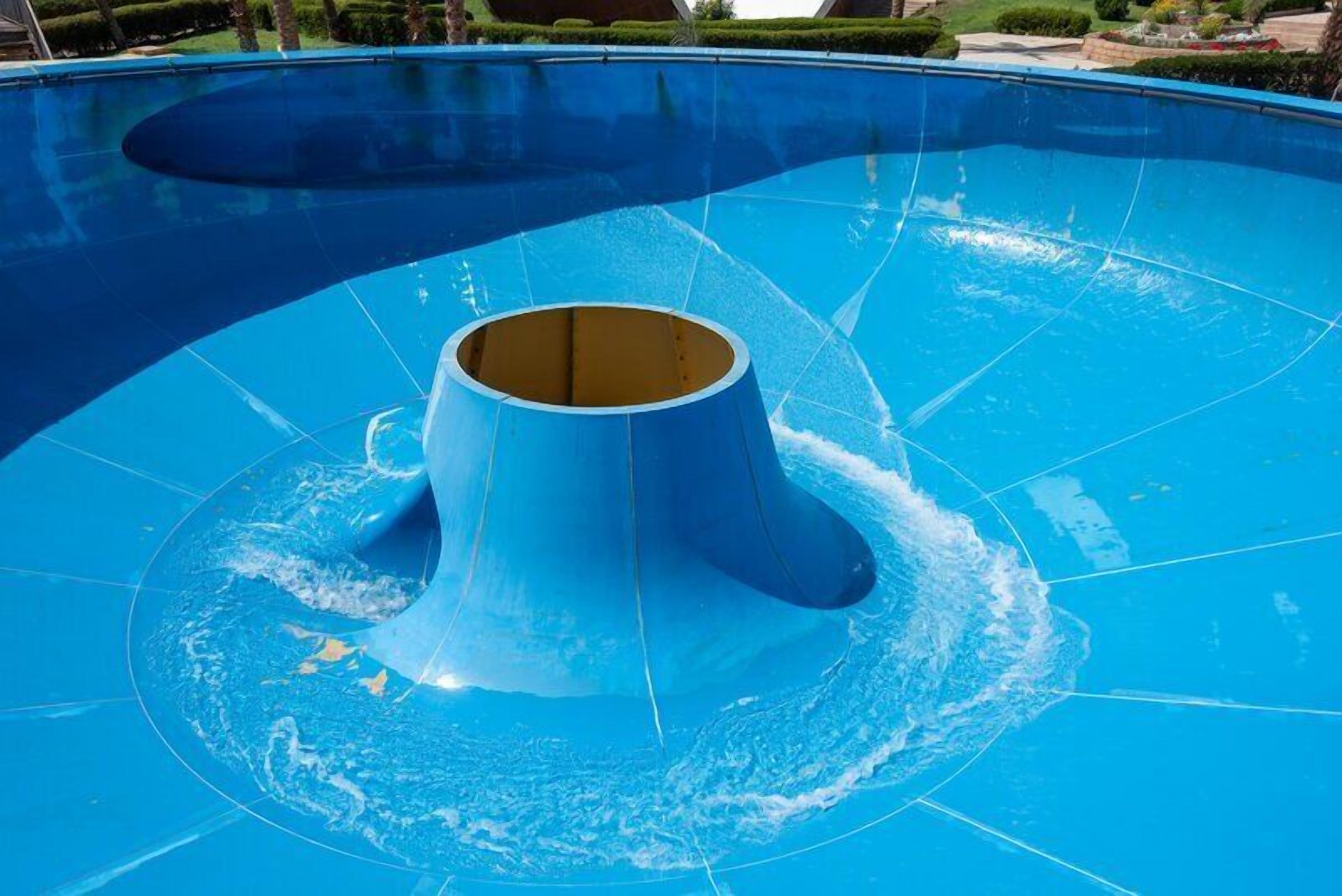 A large, blue swimming pool with a central water slide.