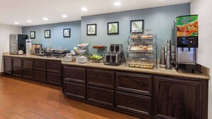 A self-service breakfast bar with a coffee machine, toaster, and fruit display. - Baymont by Wyndham Barstow Historic Route 66 (Barstow)
