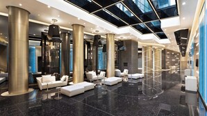 A spacious lobby with high ceilings, large pillars, and modern seating areas. - Excelsior Hotel Gallia, a Luxury Collection Hotel, Milan (Milan)