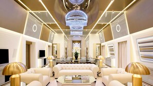 A luxurious interior with a central seating area, a chandelier, and modern decor. - Excelsior Hotel Gallia, a Luxury Collection Hotel, Milan (Milan)