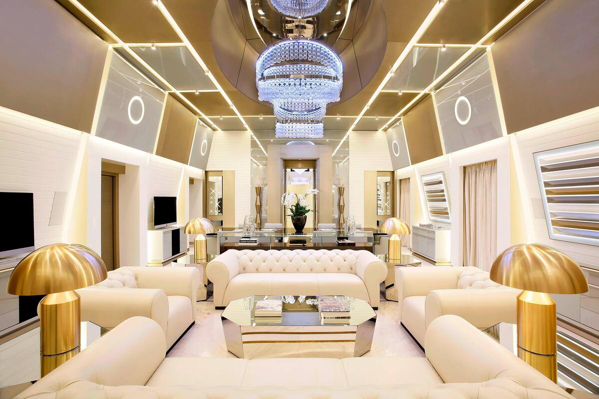 A luxurious interior with a central seating area, a chandelier, and modern decor.