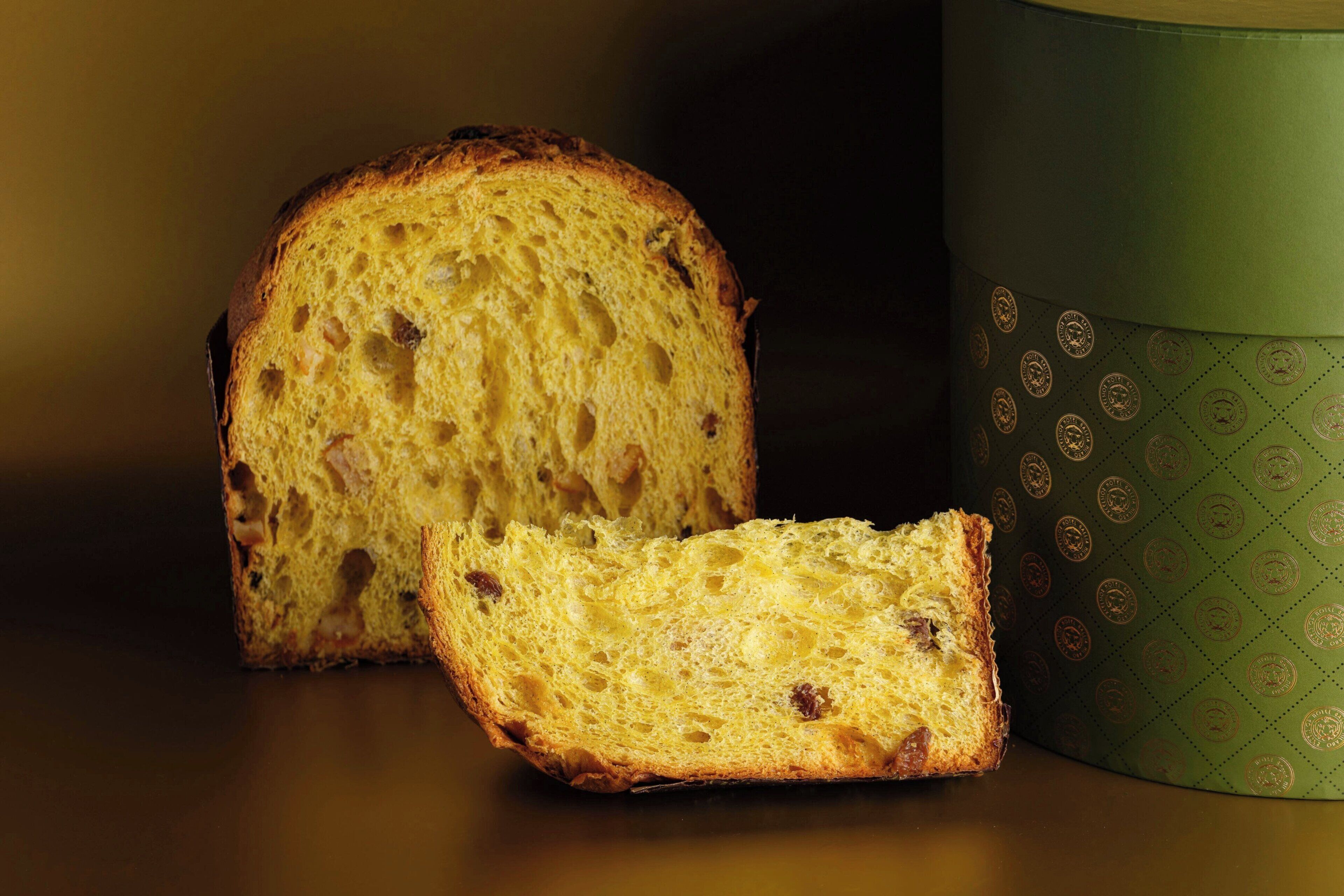 A loaf of bread and a green container with a pattern.