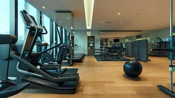 A gym with treadmills, exercise balls, and weight machines.