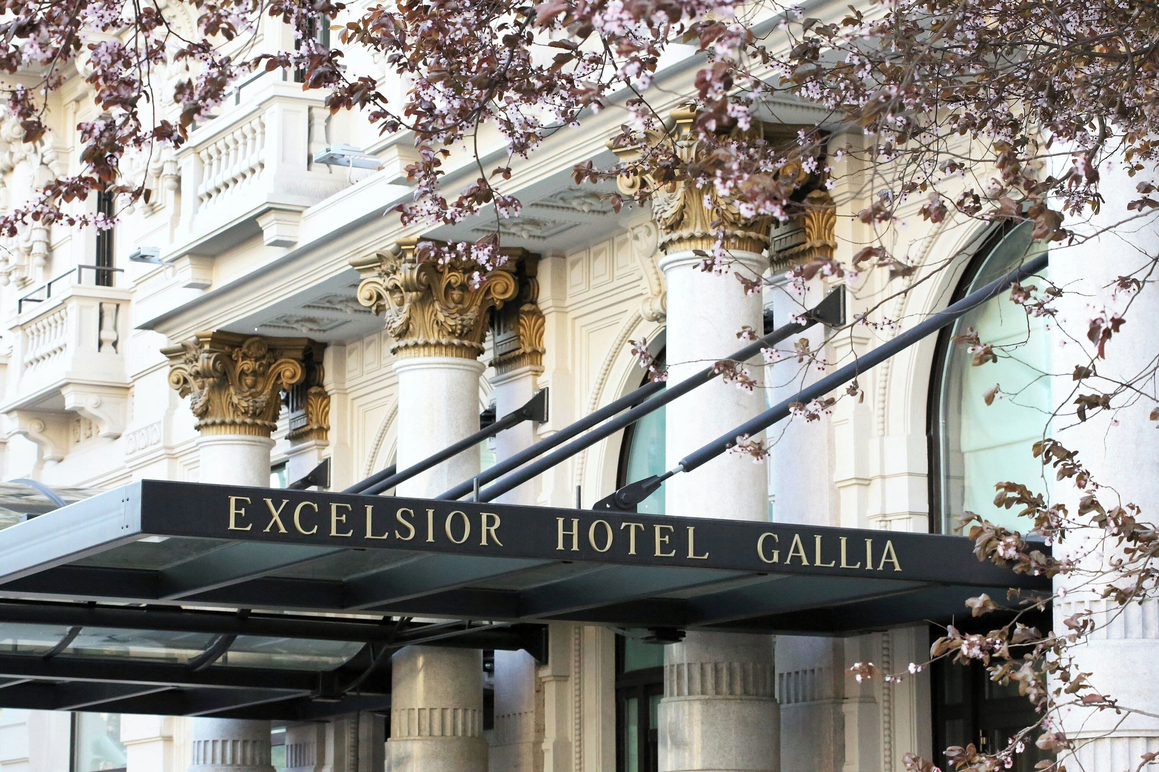 The entrance to Excelsior Hotel Gallia with classical architecture and a prominent sign.