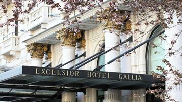 The entrance to Excelsior Hotel Gallia with classical architecture and a prominent sign.