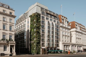 A multi-story hotel with a prominent vertical garden feature, large windows, and classic architectural design. - The Athenaeum Hotel & Residences (London)