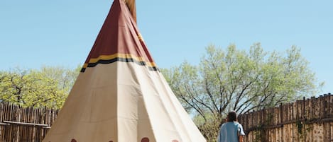 A conical structure with a person standing in front.