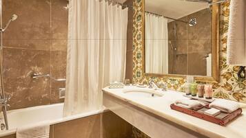 A bathroom with a bathtub, shower, and sink.