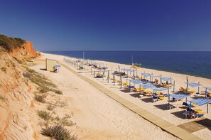 On the beach, sun-loungers, beach umbrellas, beach towels