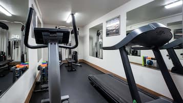 A gym with treadmills, a bench, and various exercise equipment.