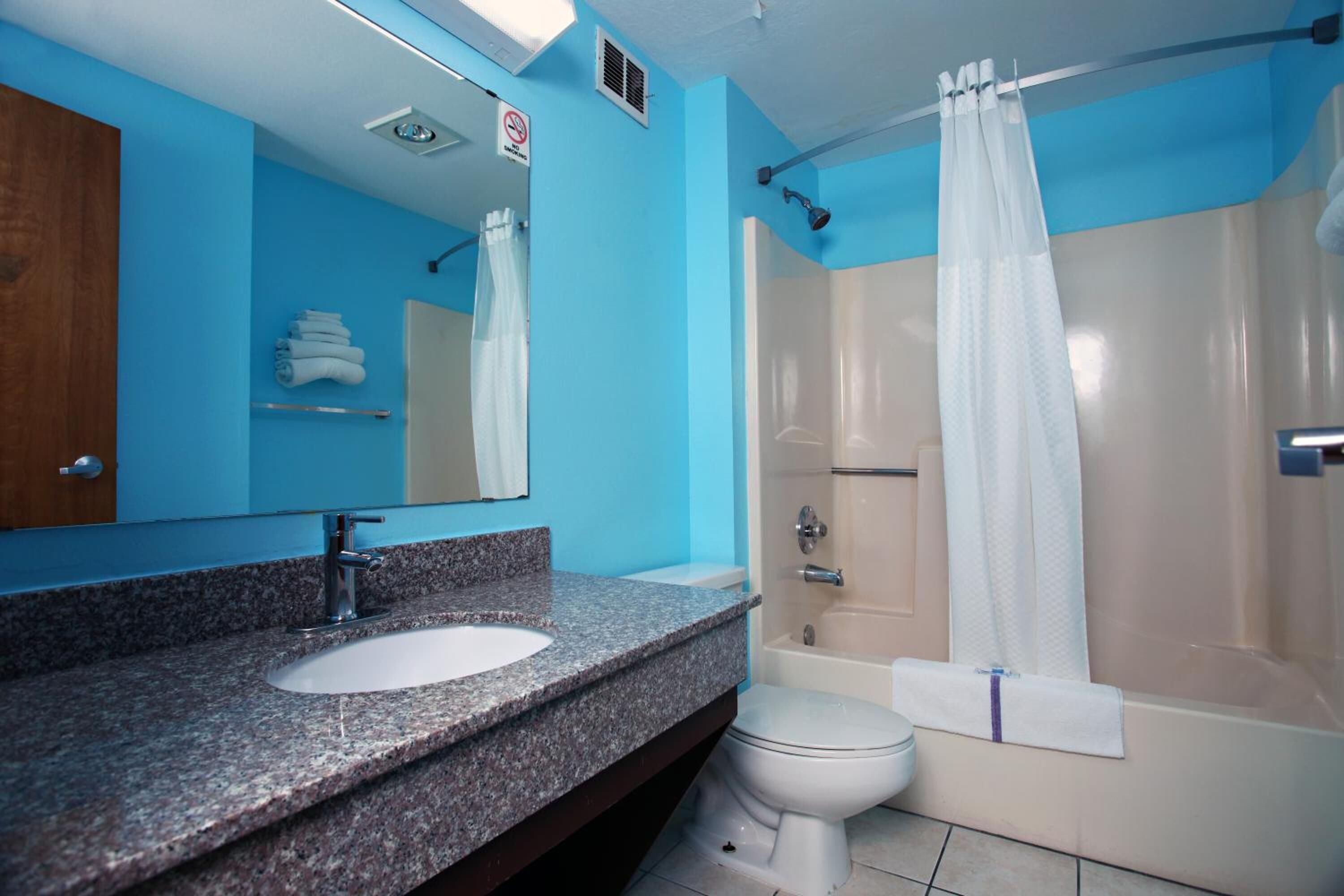 Separate tub and shower, designer toiletries, hair dryer, bathrobes