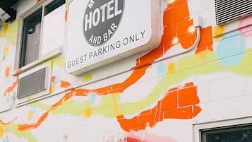 A hotel sign with colorful abstract designs on the wall.