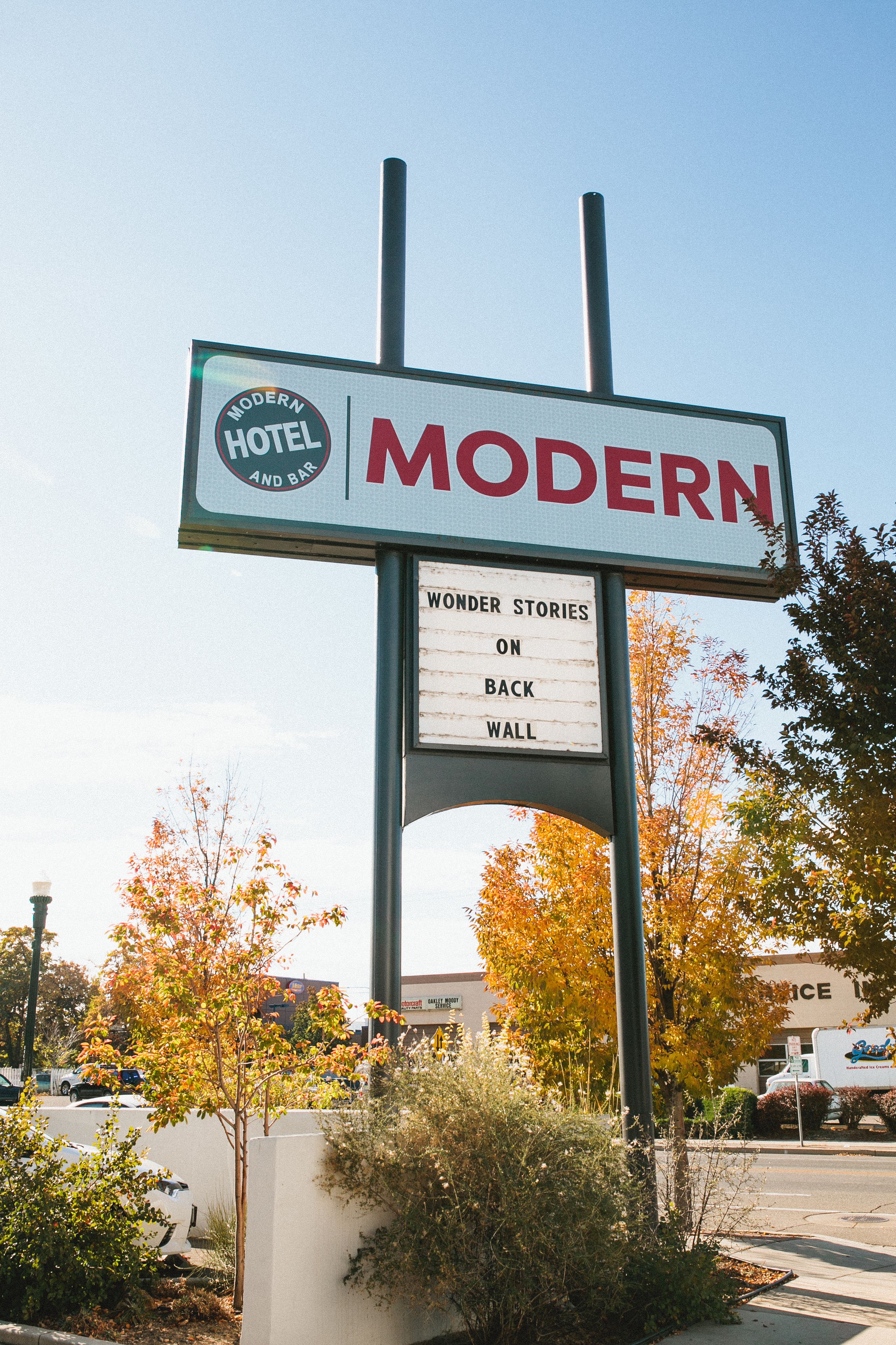 A sign for a hotel named "Modern Hotel and Bar" with a section titled "Wonder Stories on Back Wall".