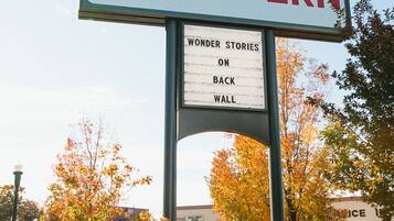 A sign for a hotel named "Modern Hotel and Bar" with a section titled "Wonder Stories on Back Wall".
