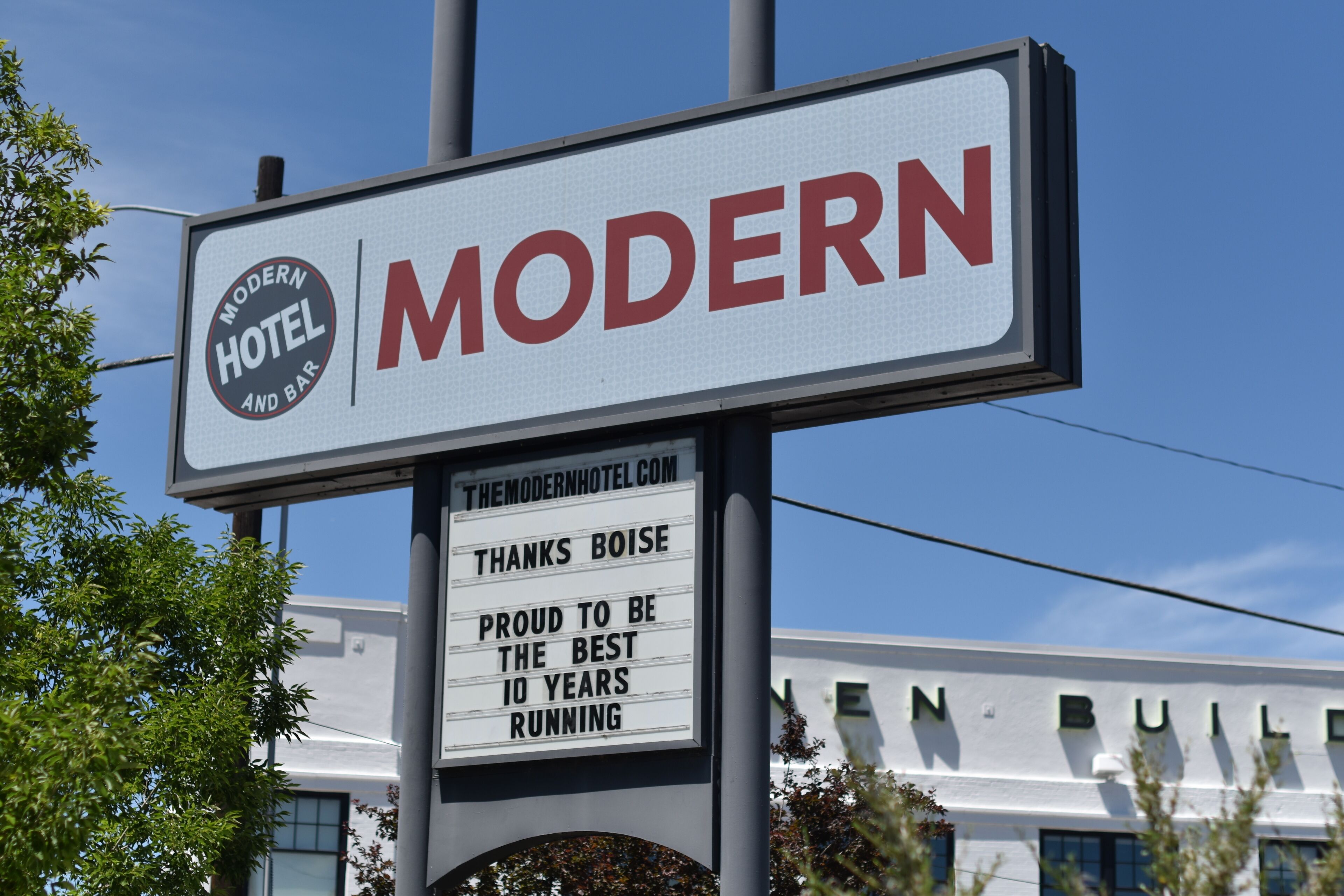 A hotel sign with the name "MODERN HOTEL AND BAR" and a message about being the best 10 years running.
