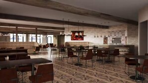 Un restaurant spacieux avec de hauts plafonds, un mobilier moderne et un sol à motifs.