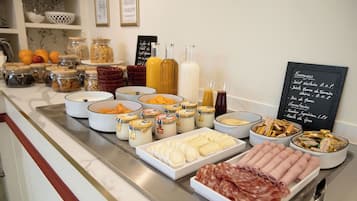 A buffet spread with various food items and condiments.