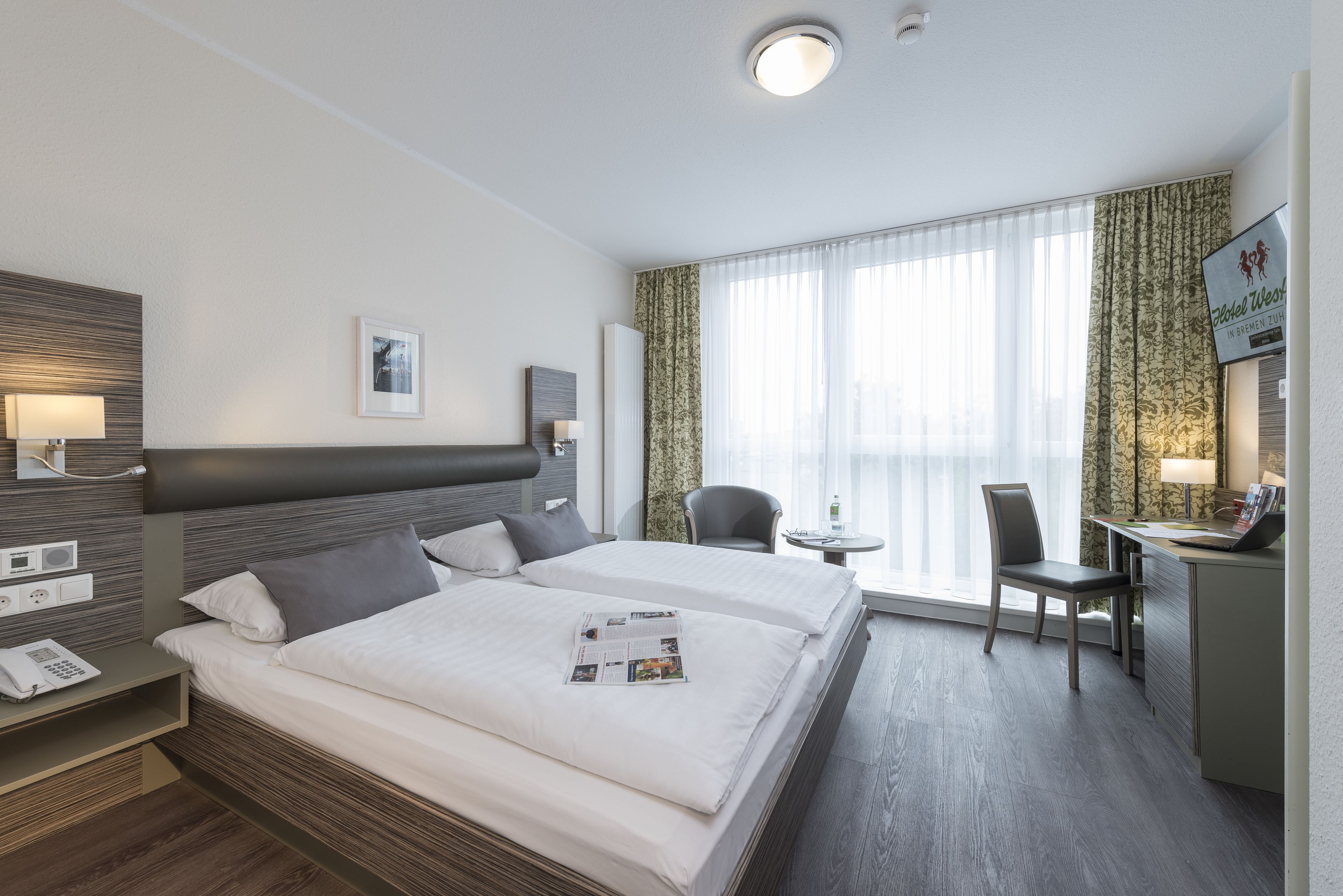 hypo-allergenic bedding, desk, laptop workspace, blackout curtains