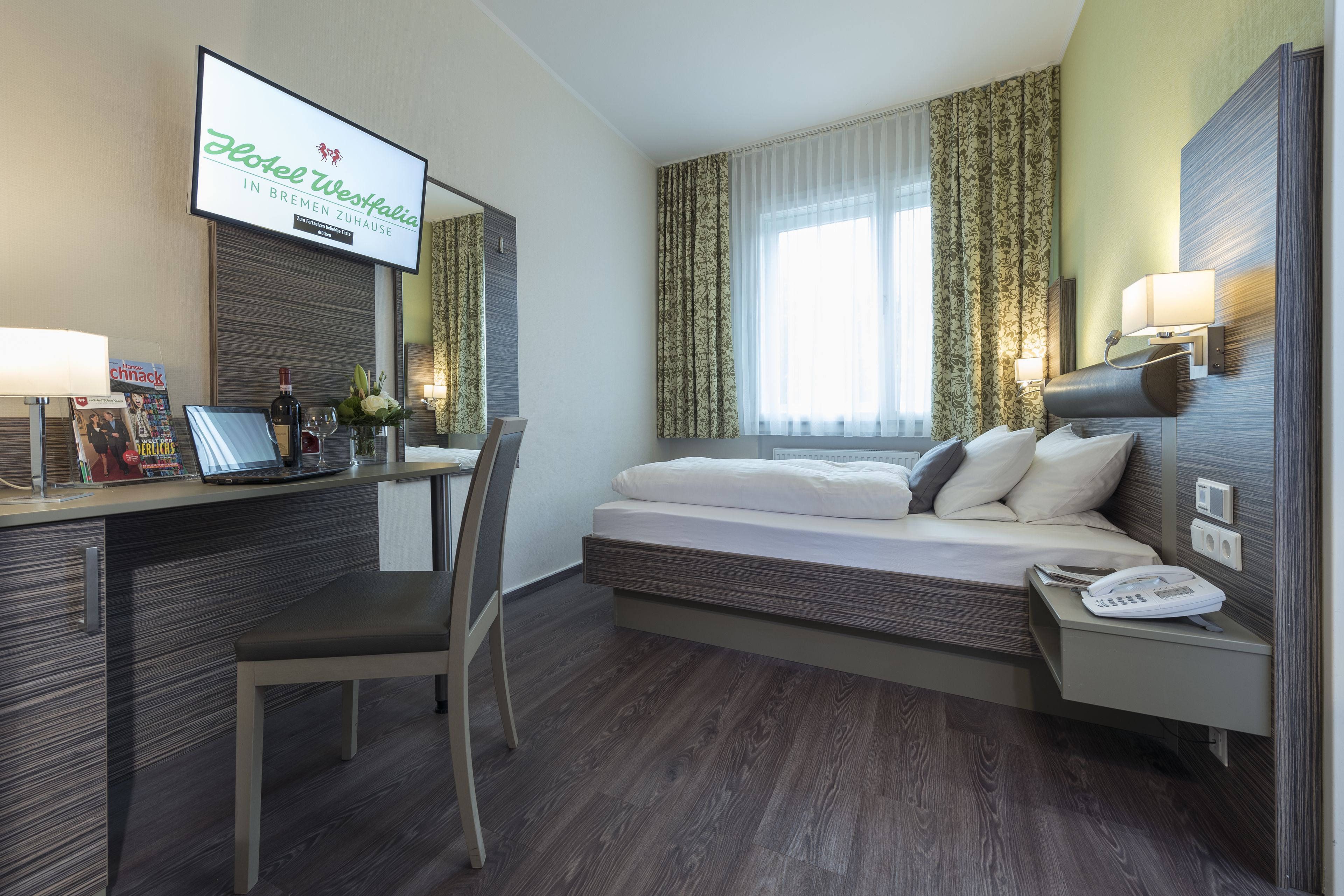 hypo-allergenic bedding, desk, laptop workspace, blackout curtains