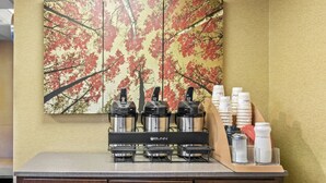 A coffee station with a Bunn espresso machine, a coffee dispenser, and a cream dispenser. - Red Roof Inn Dayton North Airport (Dayton)