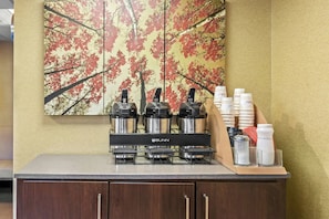 A coffee station with a Bunn espresso machine, a coffee dispenser, and a cream dispenser. - Red Roof Inn Dayton North Airport (Dayton)