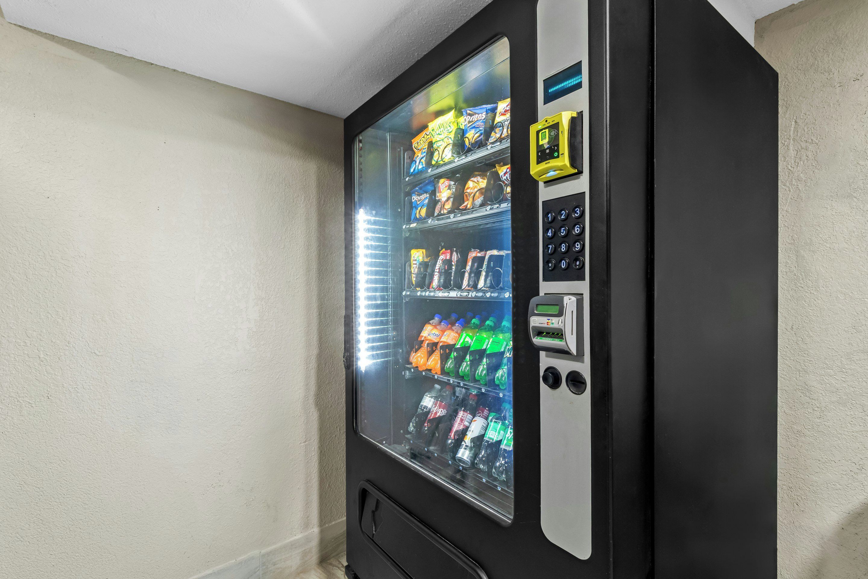 A vending machine with a glass door, containing various snacks and beverages.
