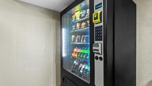 A vending machine with a glass door, containing various snacks and beverages. - Red Roof Inn Dayton North Airport (Dayton)