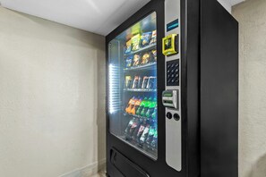 A vending machine with a glass door, containing various snacks and beverages. - Red Roof Inn Dayton North Airport (Dayton)