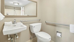 A bathroom with a sink, toilet, and mirror. - Red Roof Inn Dayton North Airport (Dayton)