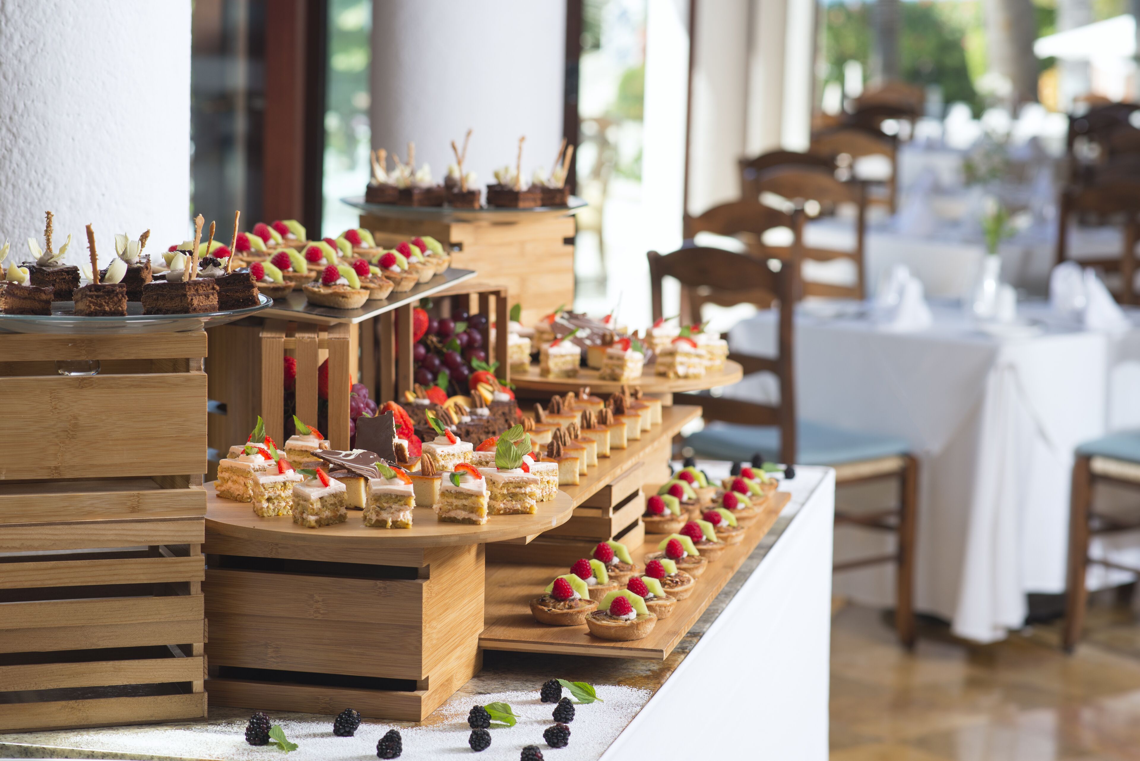 A buffet table with various desserts and snacks.
