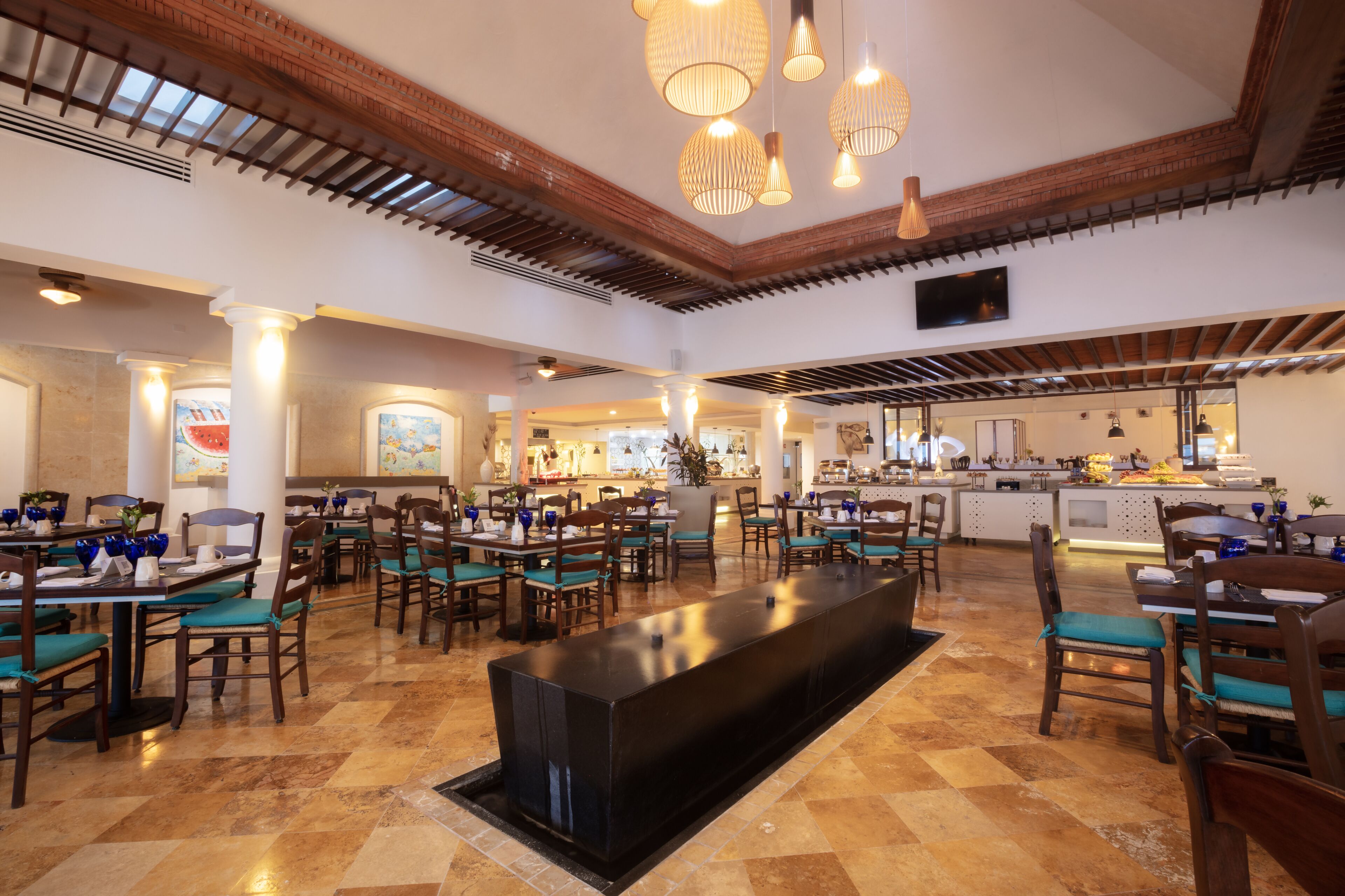 A spacious restaurant with high ceilings, exposed beams, and a central bar area.