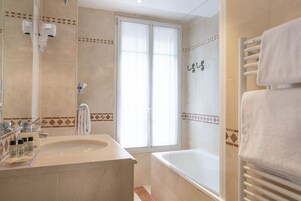 A bathroom with a bathtub, a sink, and a shower.