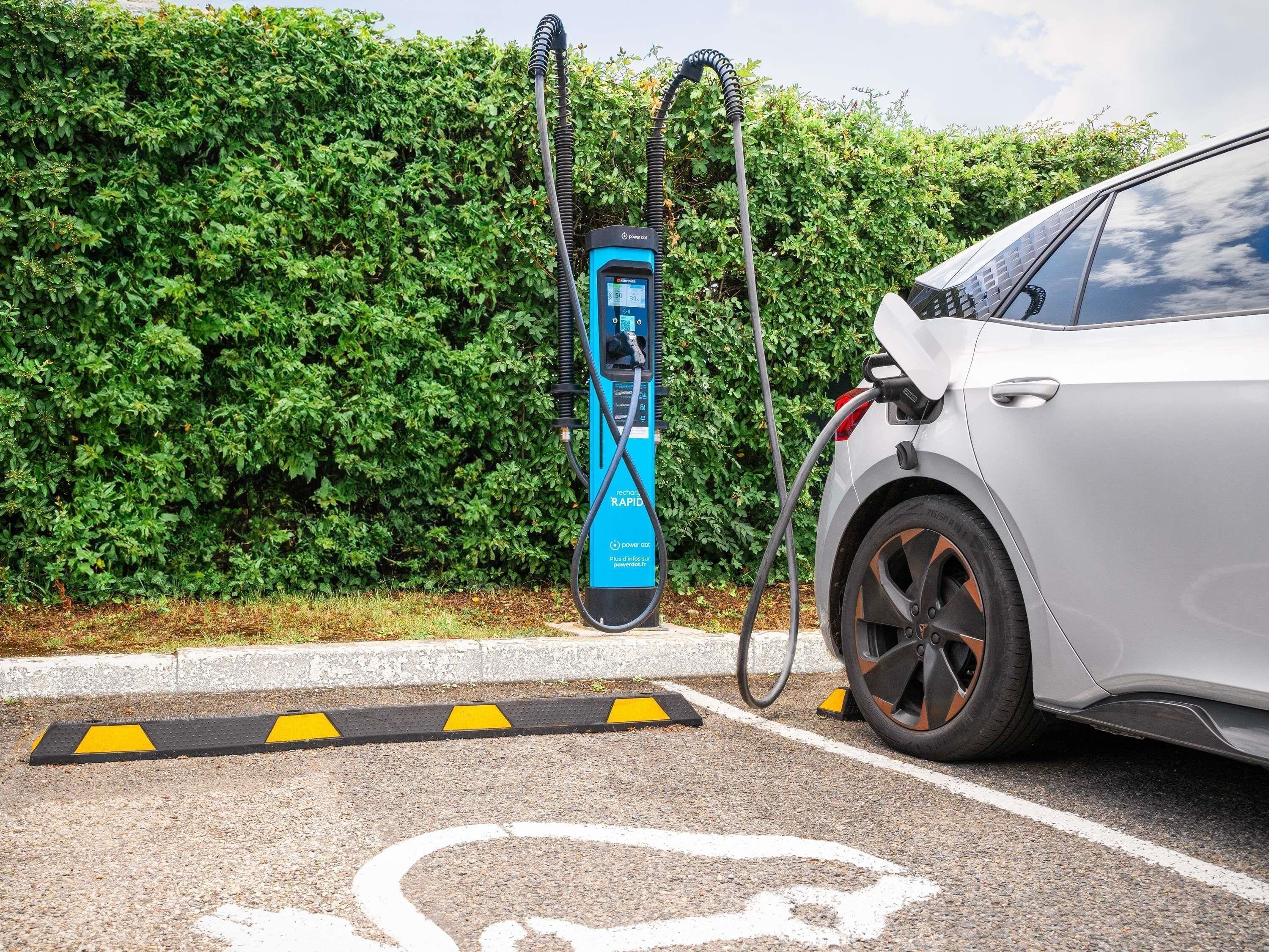A car charging at a public electric vehicle charging station.