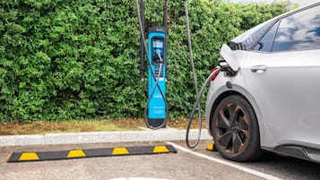 A car charging at a public electric vehicle charging station.